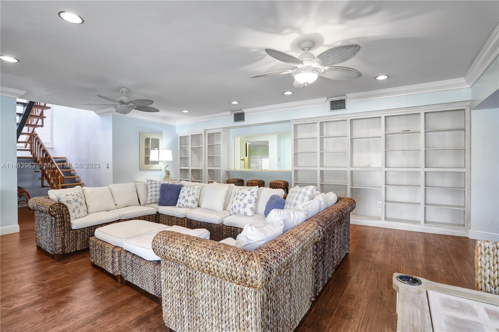 7700 Hawthorne Avenue Miami Beach, FL 33141 - Photo 11 of 36 a living room with furniture and a chandelier