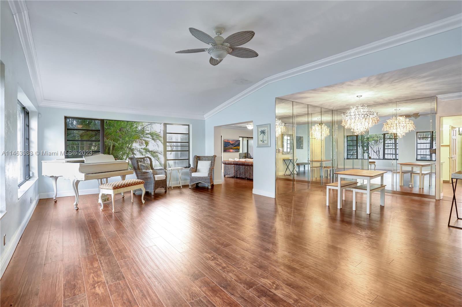 7700 Hawthorne Avenue Miami Beach, FL 33141 - Photo 12 of 36 a living room with furniture and a large window with garden view