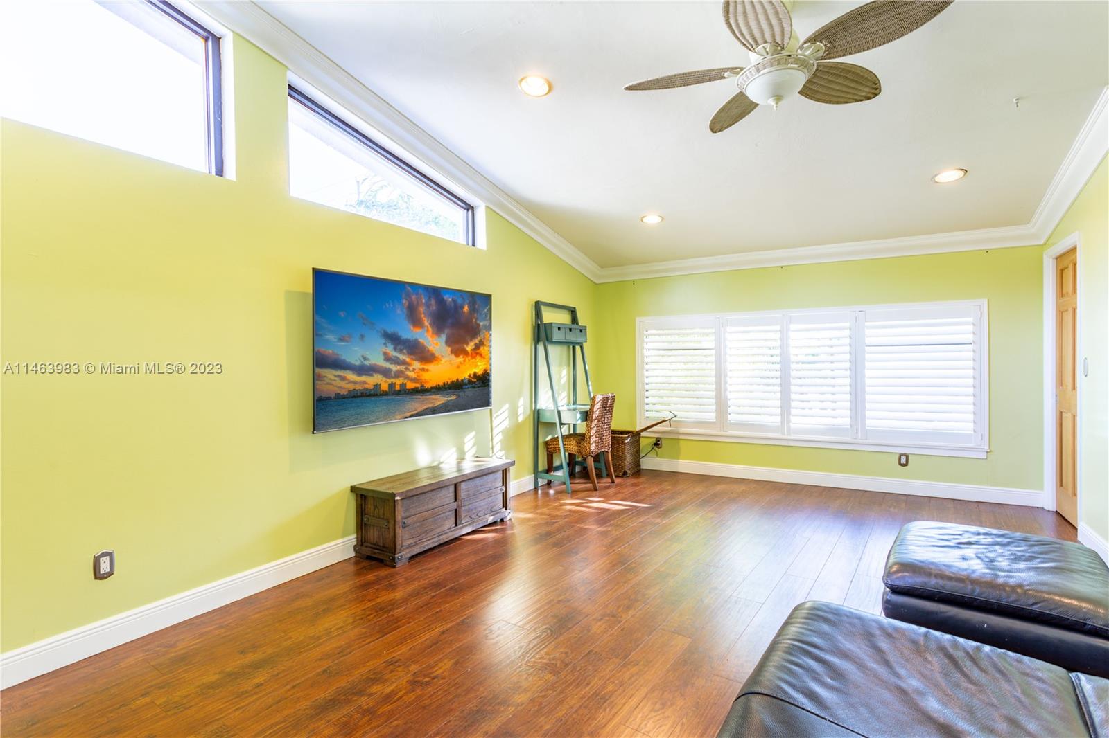 7700 Hawthorne Avenue Miami Beach, FL 33141 - Photo 16 of 36 a living room with furniture and a flat screen tv