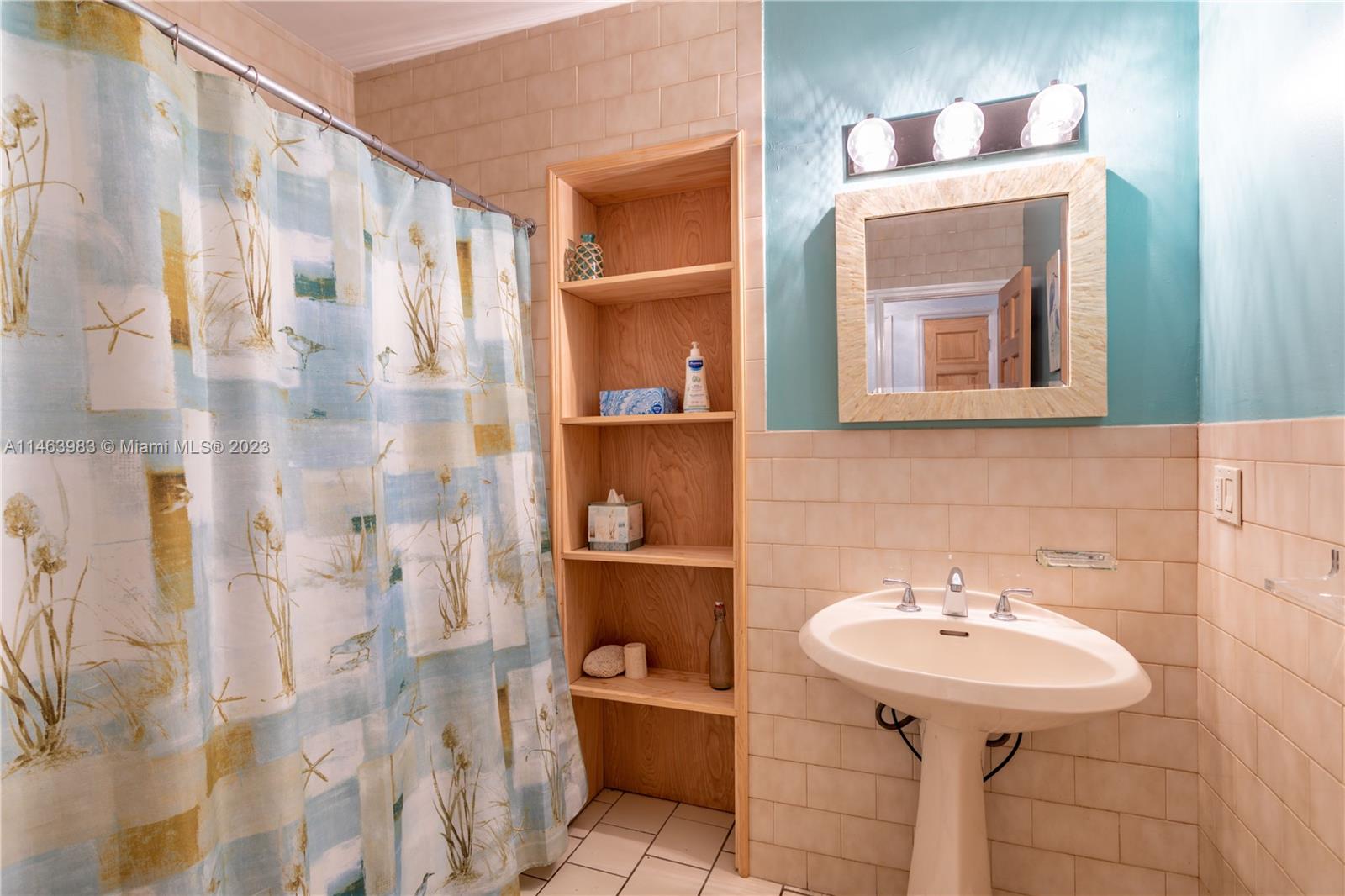 7700 Hawthorne Avenue Miami Beach, FL 33141 - Photo 20 of 36 a bathroom with a sink and a mirror