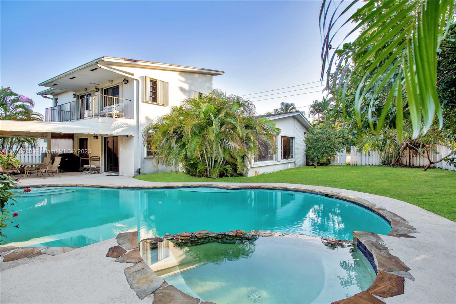7700 Hawthorne Avenue Miami Beach, FL 33141 - Photo 2 of 36 a front view of a house with swimming pool having outdoor seating