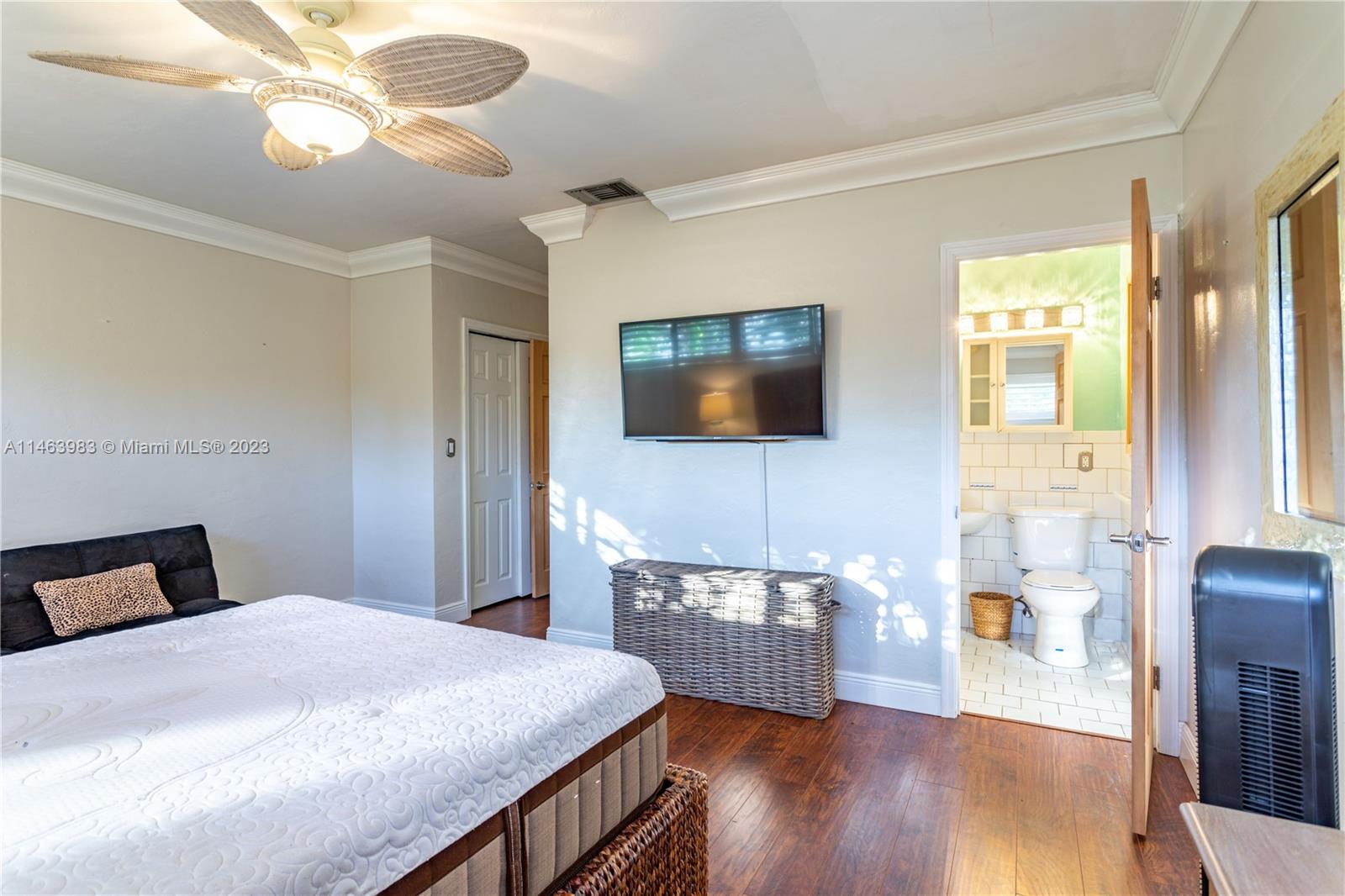 7700 Hawthorne Avenue Miami Beach, FL 33141 - Photo 22 of 36 a bedroom with a bed and wooden floor
