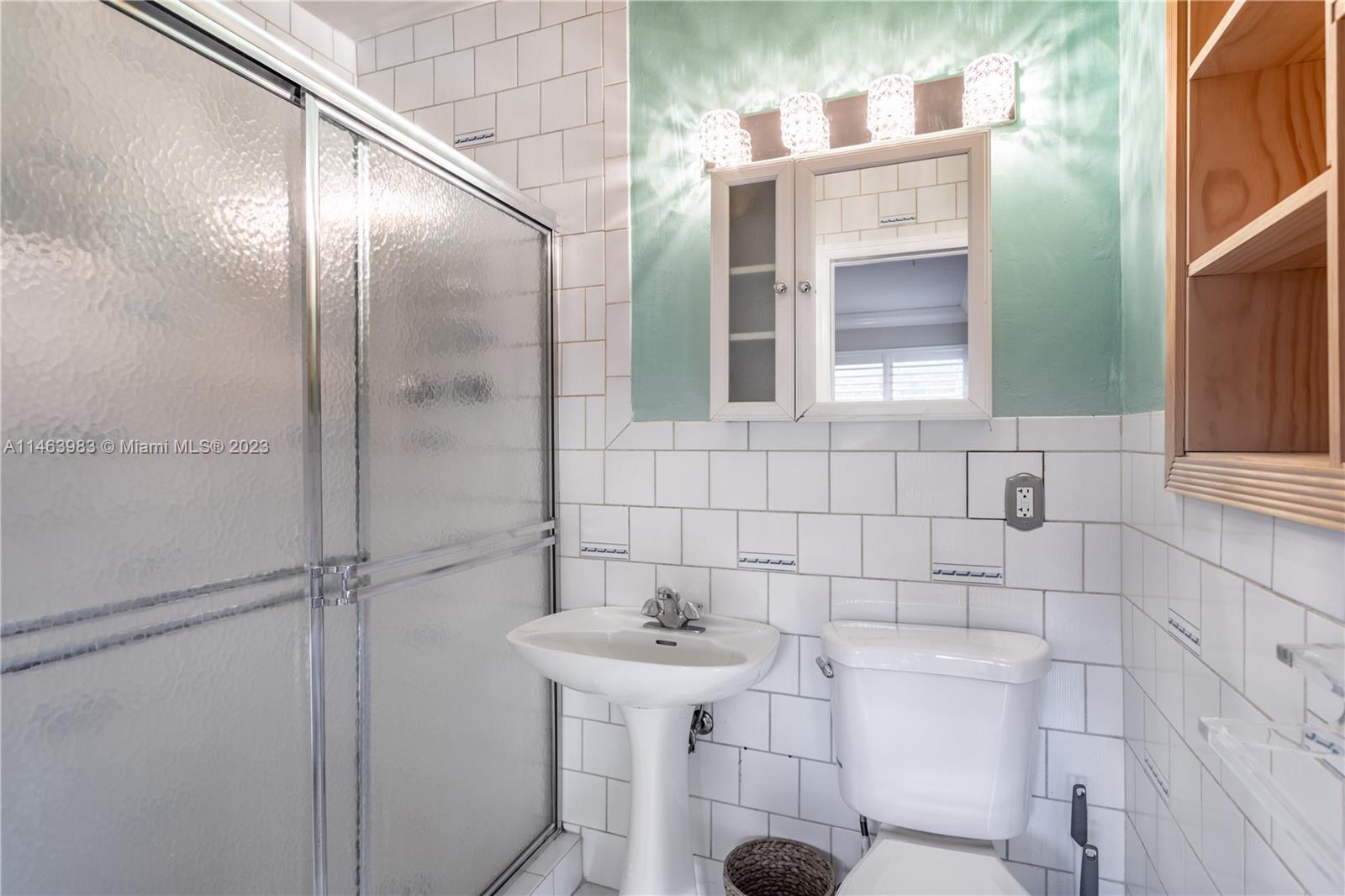 7700 Hawthorne Avenue Miami Beach, FL 33141 - Photo 23 of 36 a bathroom with a sink and mirror
