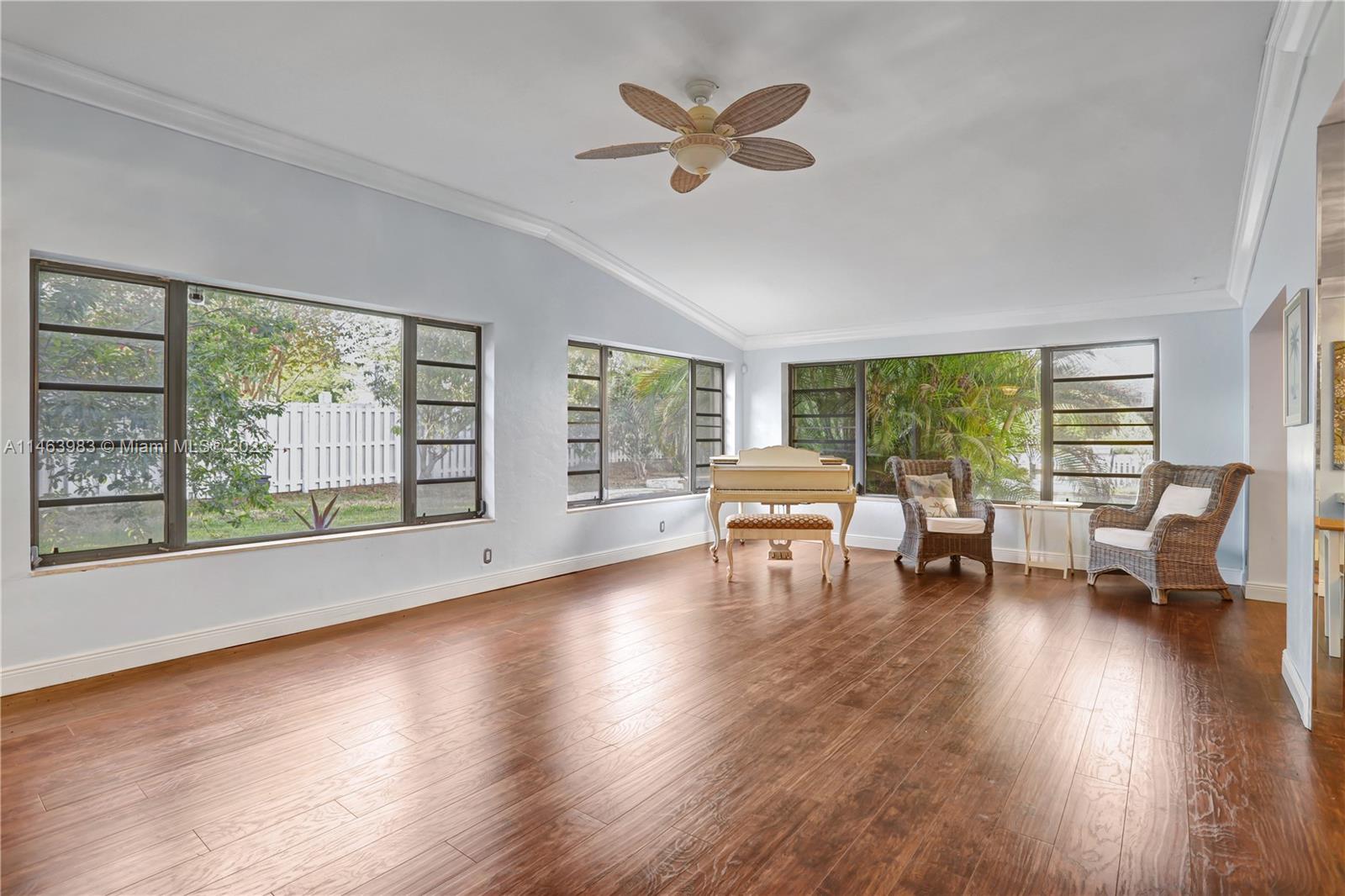 7700 Hawthorne Avenue Miami Beach, FL 33141 - Photo 26 of 36 a living room with furniture and a large window with wooden floor