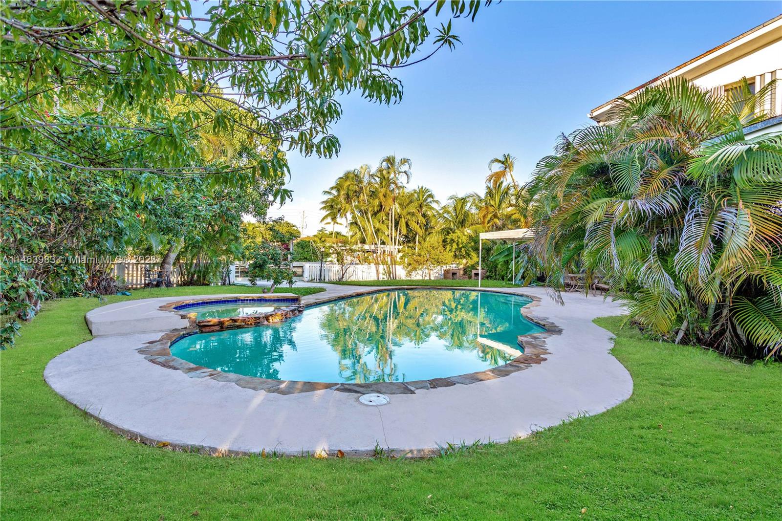 7700 Hawthorne Avenue Miami Beach, FL 33141 - Photo 3 of 36 a view of a garden with a fountain