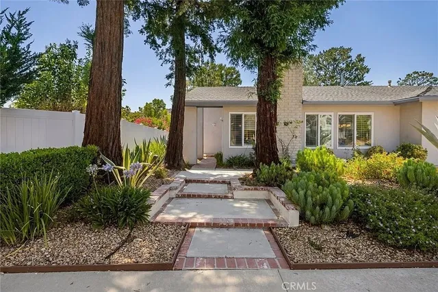 front view of a house with potted plants