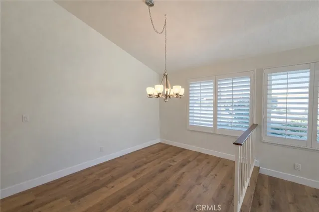 a view of a room with wooden floor and a window