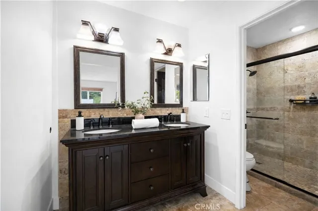a bathroom with a double vanity sink and a mirror
