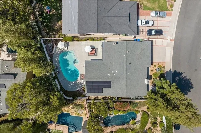 an aerial view of a house with a yard