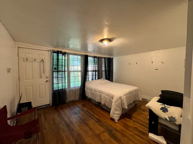 a spacious bedroom with a bed and a window