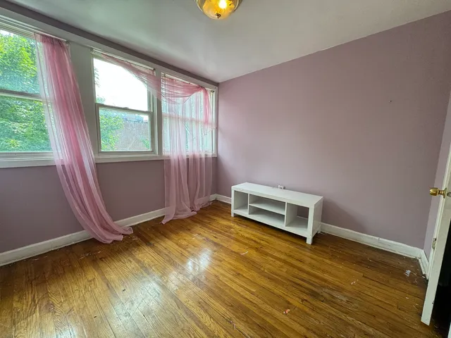 a view of room with window and wooden floor