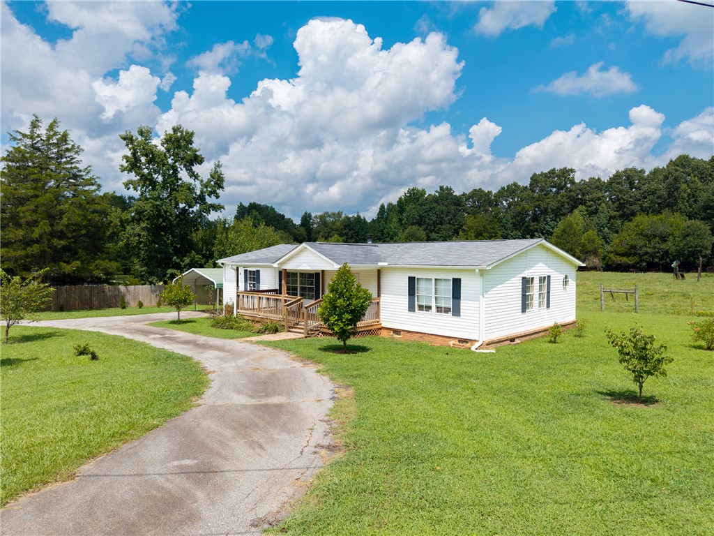 503 Mulliken Road Central, SC 29630 - Photo 28 of 50 A winding driveway leads to this charming white-sided residence nestled amidst lush greenery.