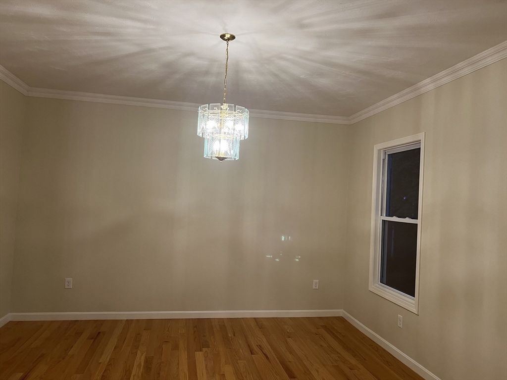 194 Auburn Street, Unit 2 Newton, MA 02466 - Photo 6 of 19 a view of an empty room with wooden floor and a window