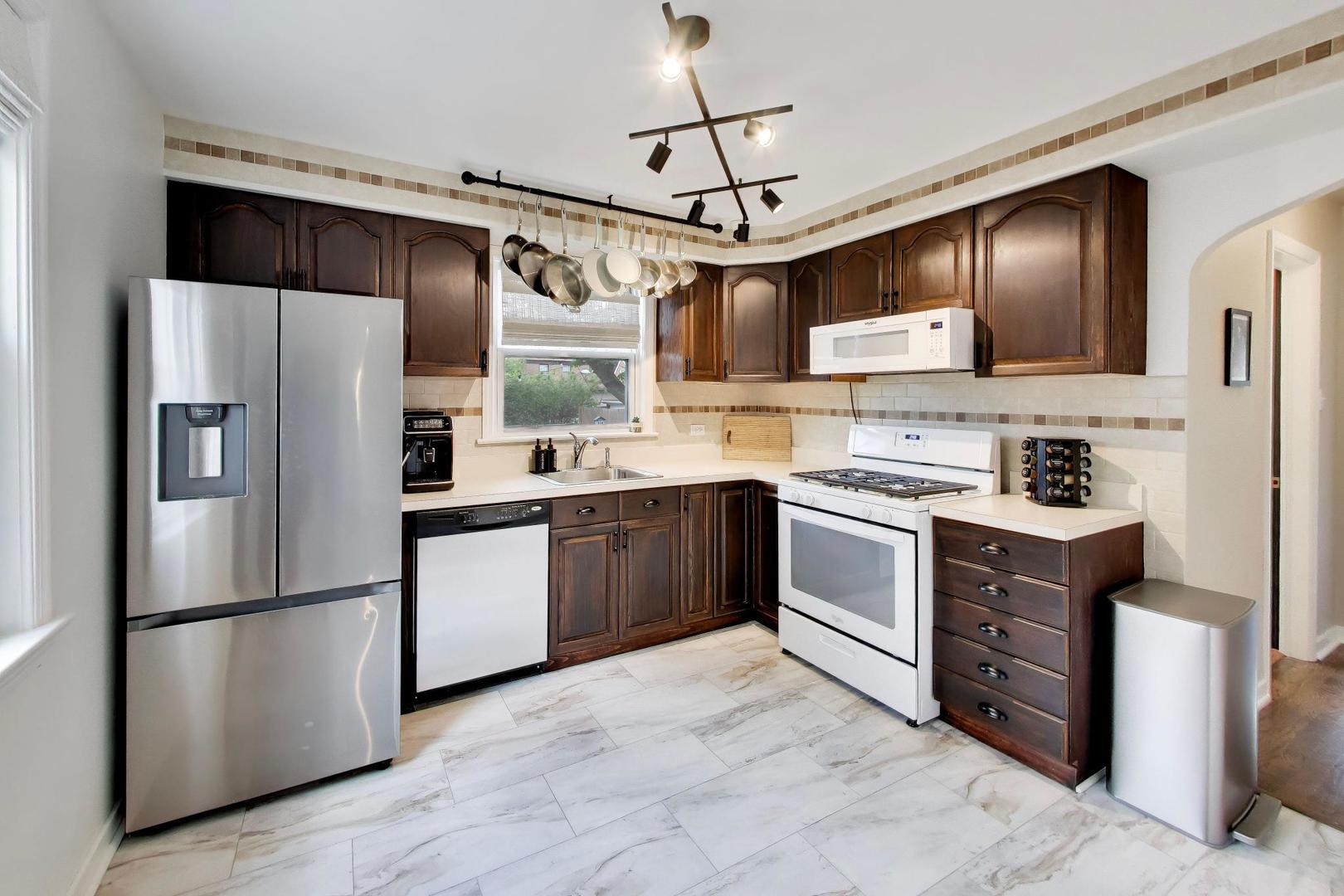 2536 5th Avenue North Riverside, IL 60546 - Photo 7 of 24 a kitchen with stainless steel appliances a refrigerator sink and cabinets