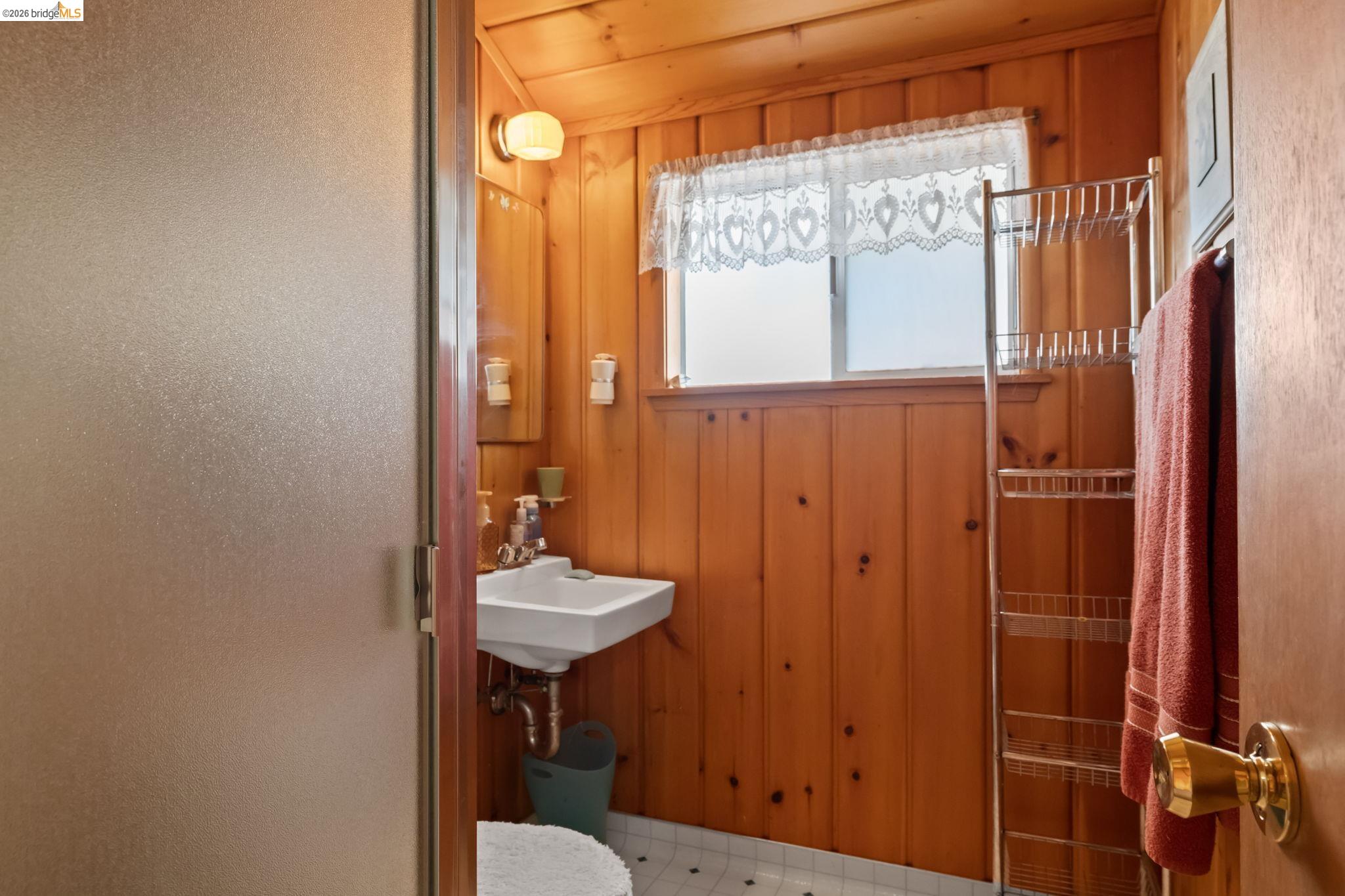 26039 Long Barn Road Long Barn, CA 95335 - Photo 23 of 27 Bathroom featuring wooden walls and light flooring