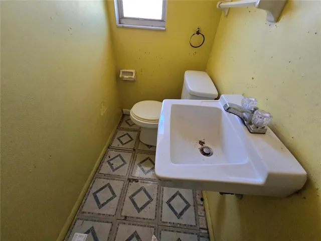 a bathroom with a sink and toilet
