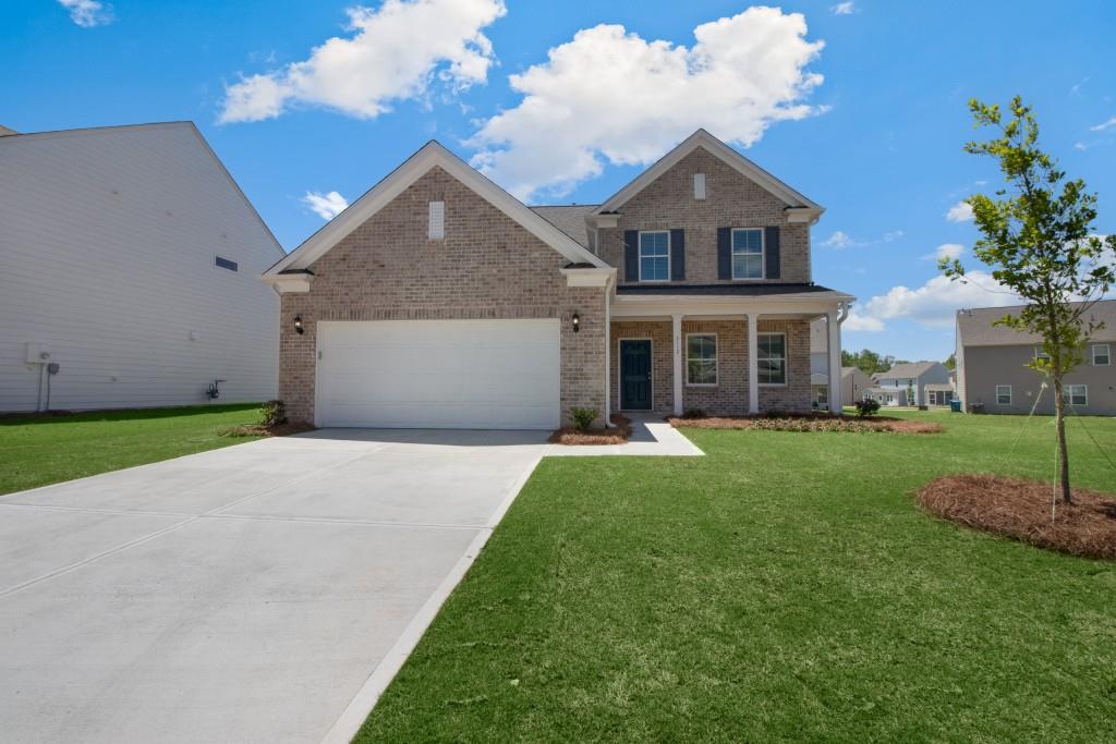 3112 Lowell Road Bethlehem, GA 30620 - Photo 1 of 1 a front view of a house with a yard and garage