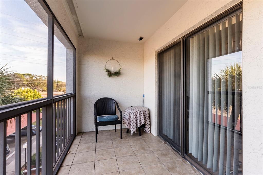 2593 Countryside Boulevard, Unit 7307 Clearwater, FL 33761 - Photo 14 of 32 a view of a balcony with furniture and floor to ceiling window