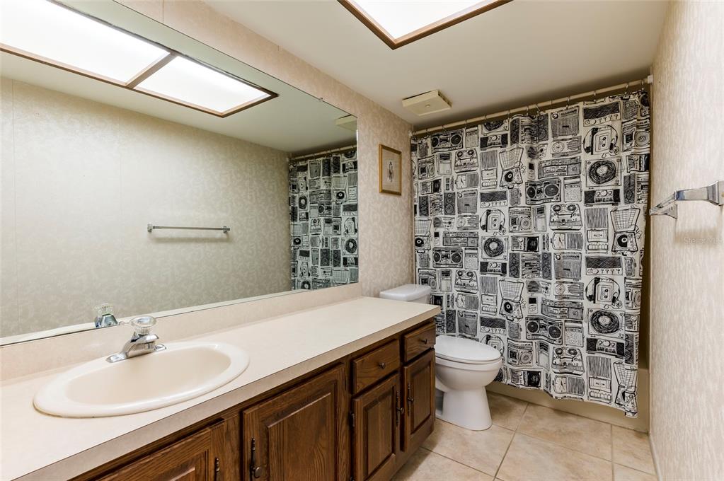 2593 Countryside Boulevard, Unit 7307 Clearwater, FL 33761 - Photo 17 of 32 a bathroom with a sink toilet and shower
