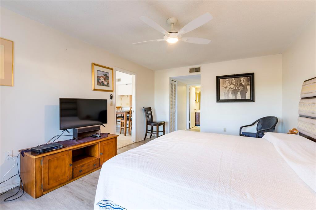 2593 Countryside Boulevard, Unit 7307 Clearwater, FL 33761 - Photo 22 of 32 a bedroom with a bed and a flat screen tv