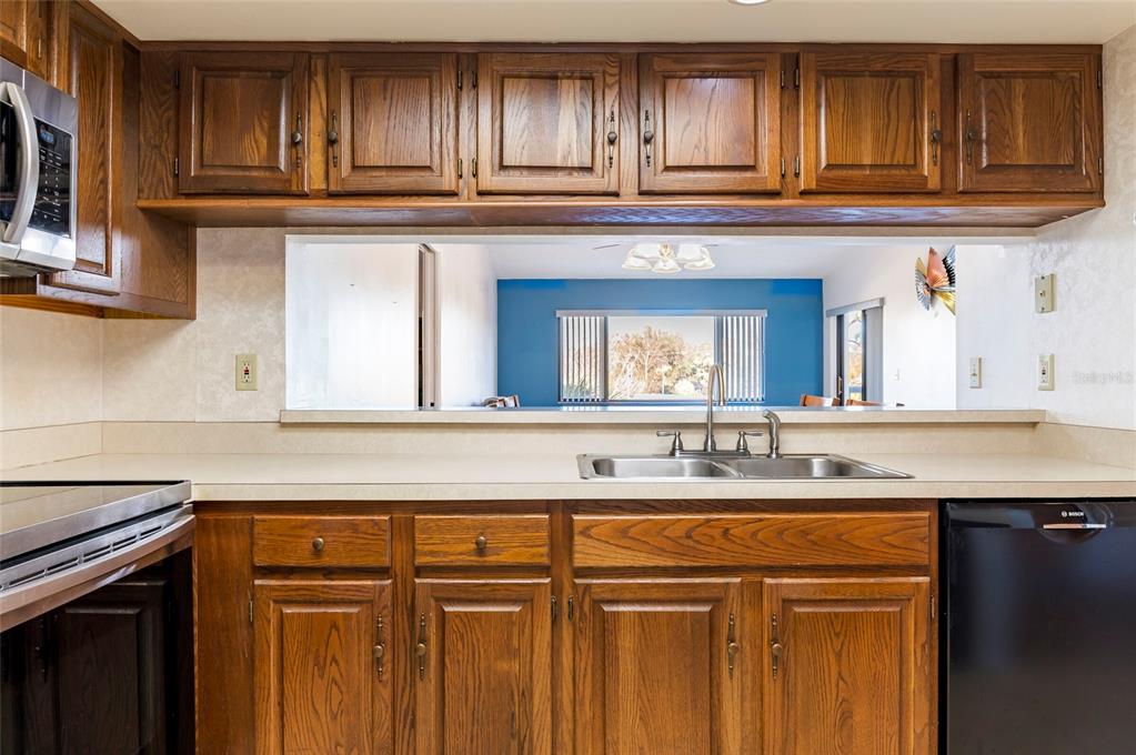 2593 Countryside Boulevard, Unit 7307 Clearwater, FL 33761 - Photo 9 of 32 a kitchen with granite countertop stainless steel appliances a sink and cabinets