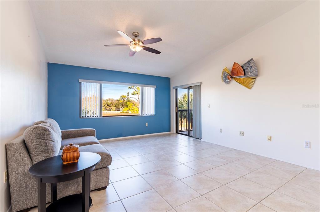 2593 Countryside Boulevard, Unit 7307 Clearwater, FL 33761 - Photo 10 of 32 a view of a livingroom with furniture and a chandelier