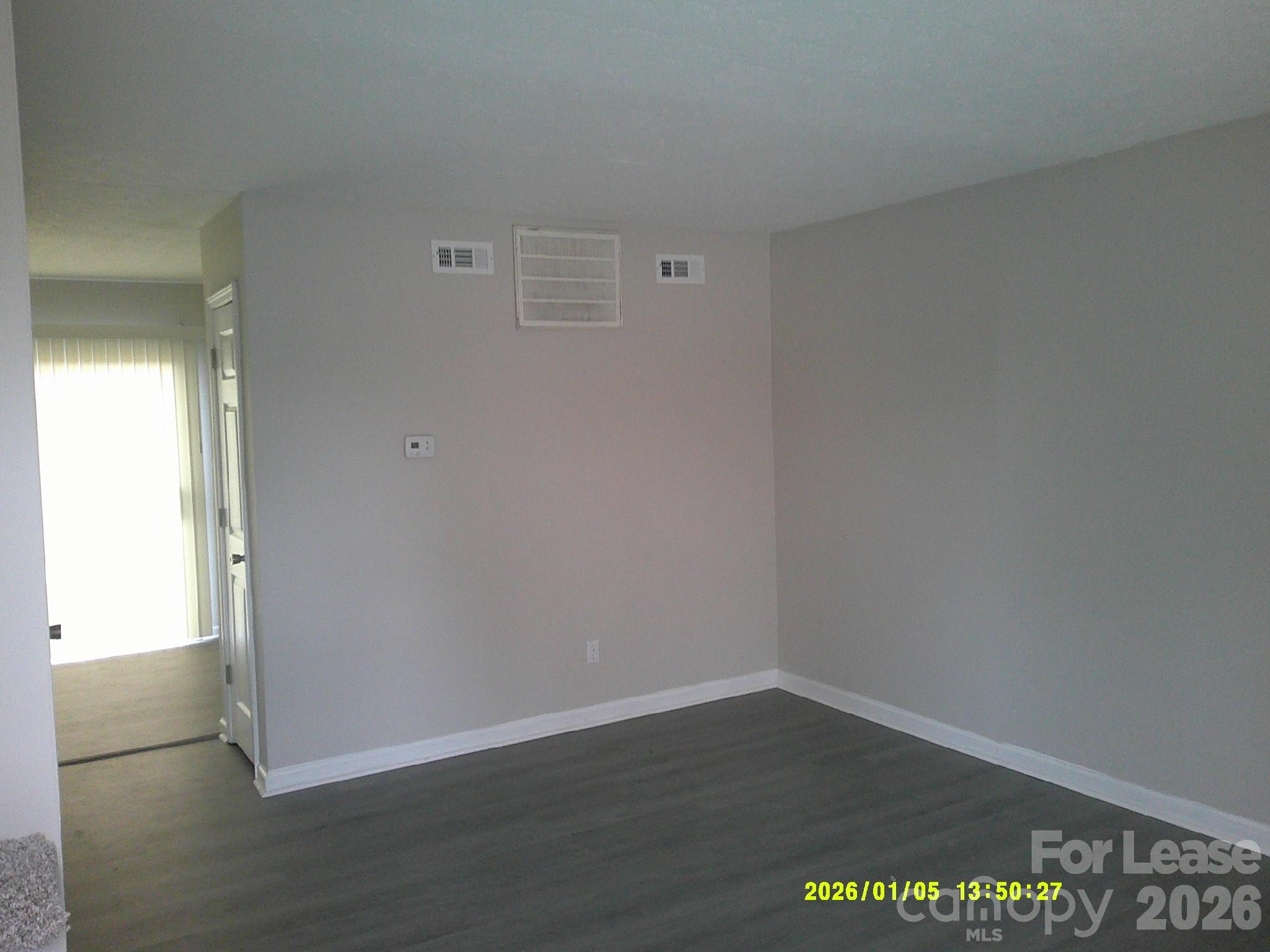 263 16th Avenue Northeast, Unit 7 Hickory, NC 28601 - Photo 2 of 8 an empty room with wooden floor and windows