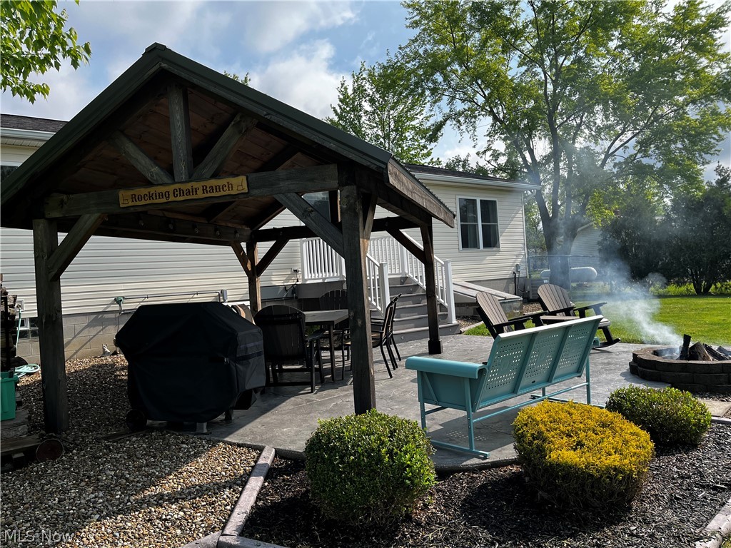 6876 Clark Road Atwater, OH 44201 - Photo 2 of 41 View of patio with area for grilling, a fire pit, and a gazebo