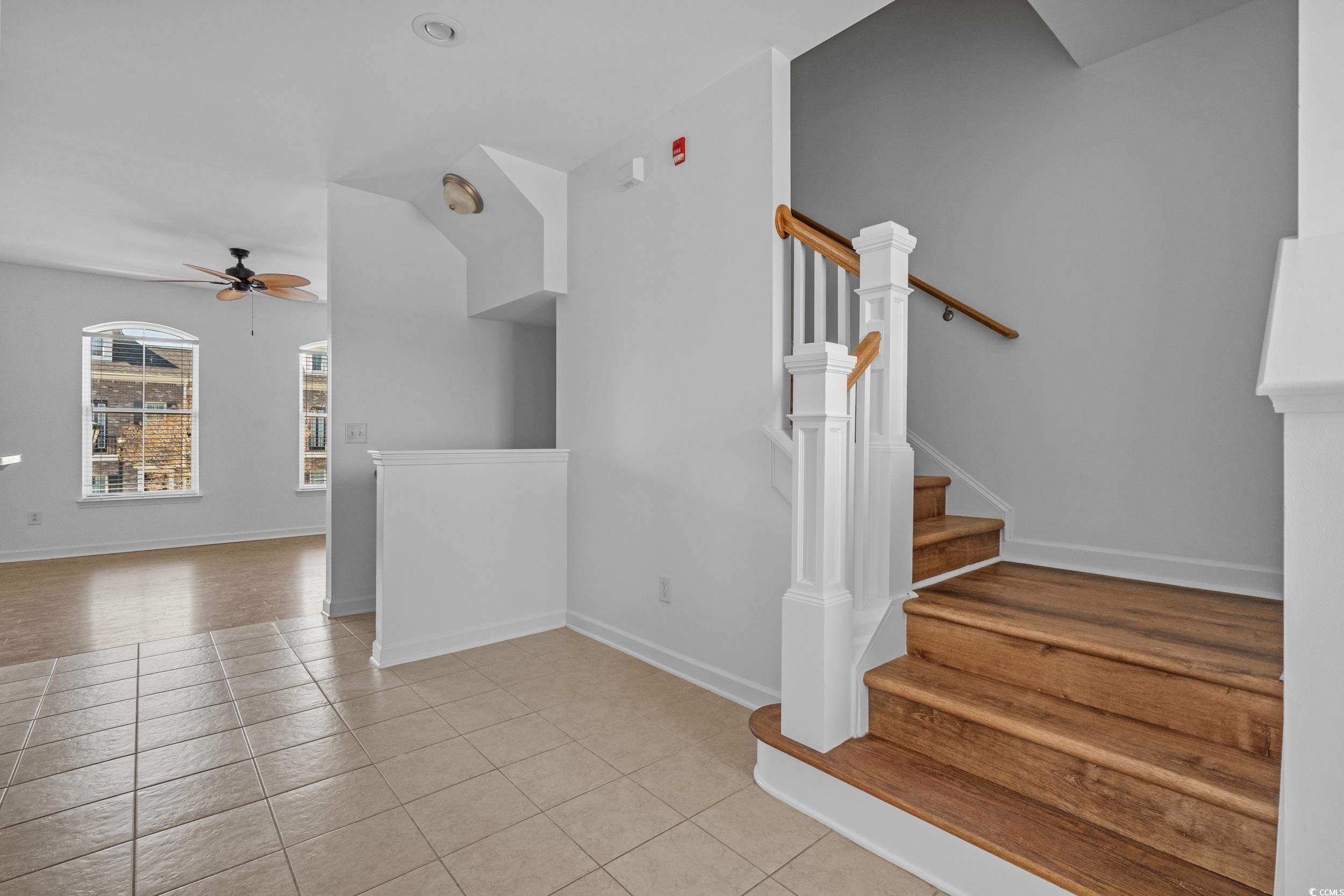 2798 Howard Avenue, Unit B Myrtle Beach, SC 29577 - Photo 17 of 40 Unfurnished living room with stairway, light tile patterned flooring, and ceiling fan