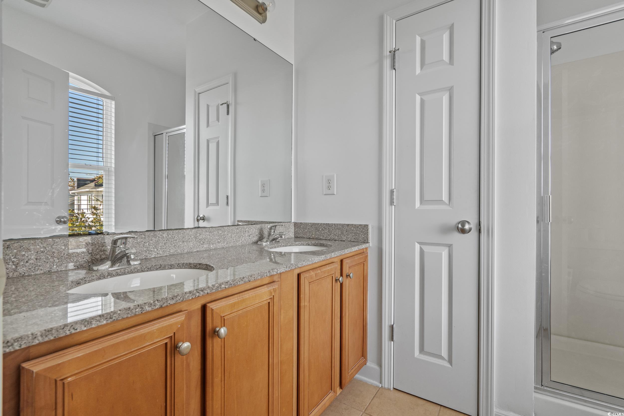 2798 Howard Avenue, Unit B Myrtle Beach, SC 29577 - Photo 20 of 40 Full bath with a shower stall, double vanity, and light tile patterned floors