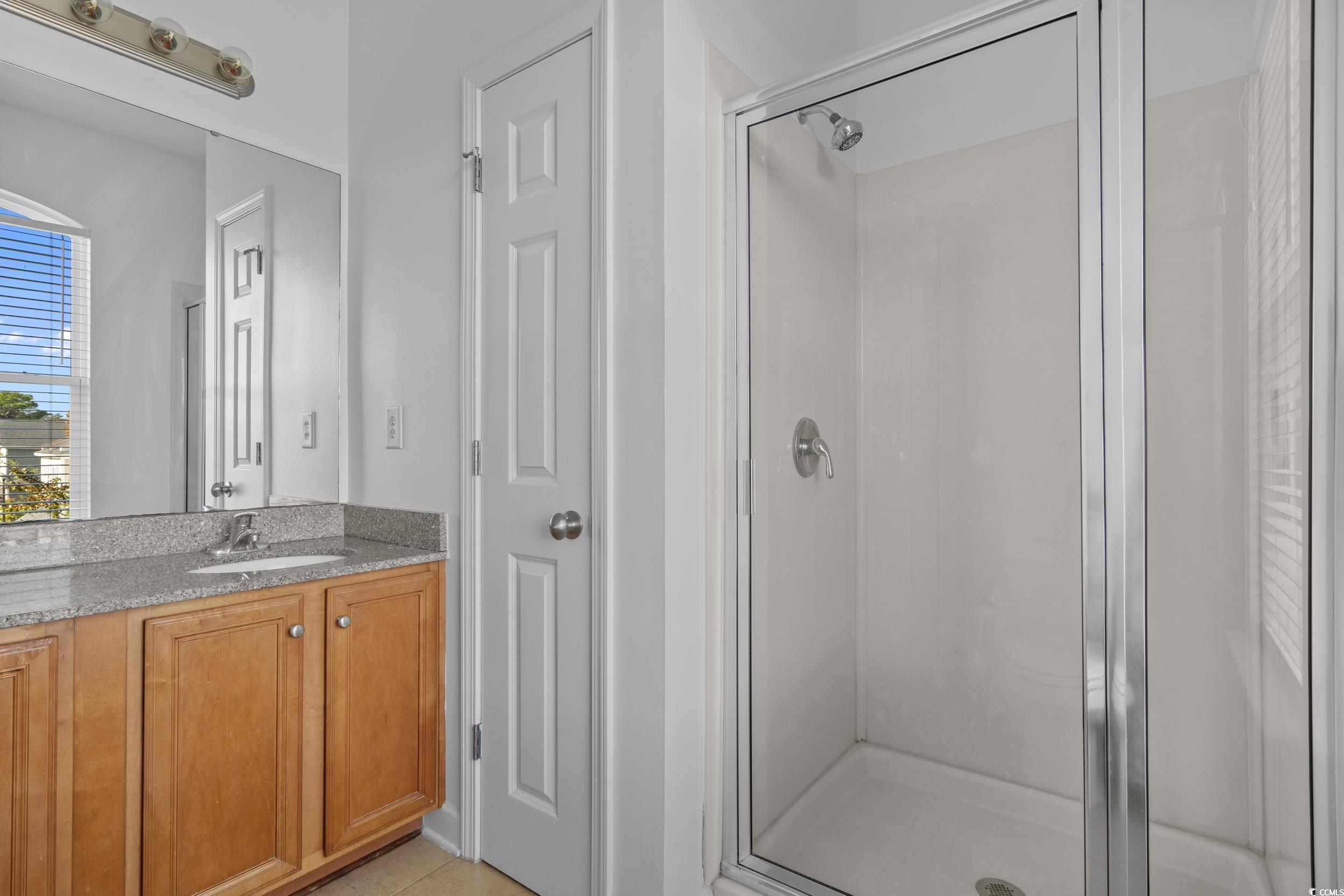 2798 Howard Avenue, Unit B Myrtle Beach, SC 29577 - Photo 21 of 40 Bathroom with vanity, a stall shower, and light tile patterned floors