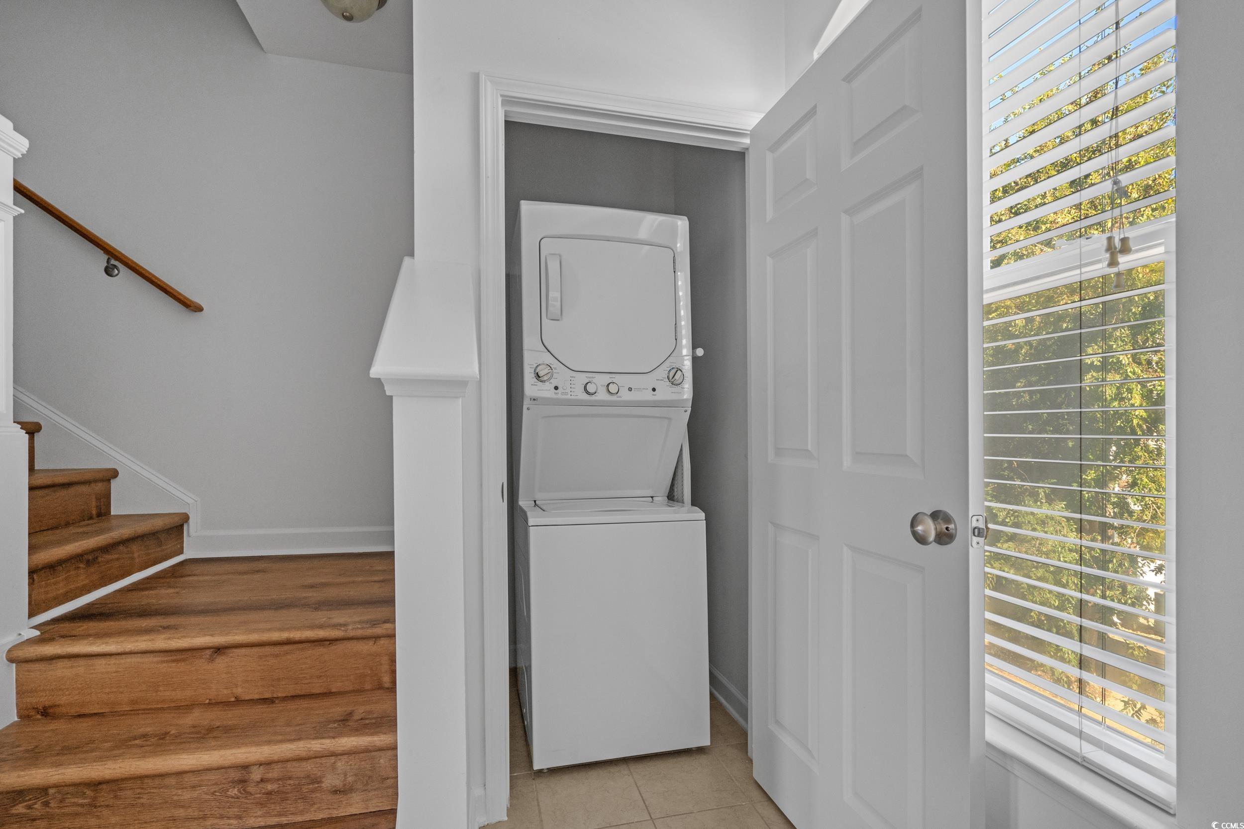 2798 Howard Avenue, Unit B Myrtle Beach, SC 29577 - Photo 26 of 40 Washroom with stacked washing machine and dryer, plenty of natural light, and light tile patterned flooring