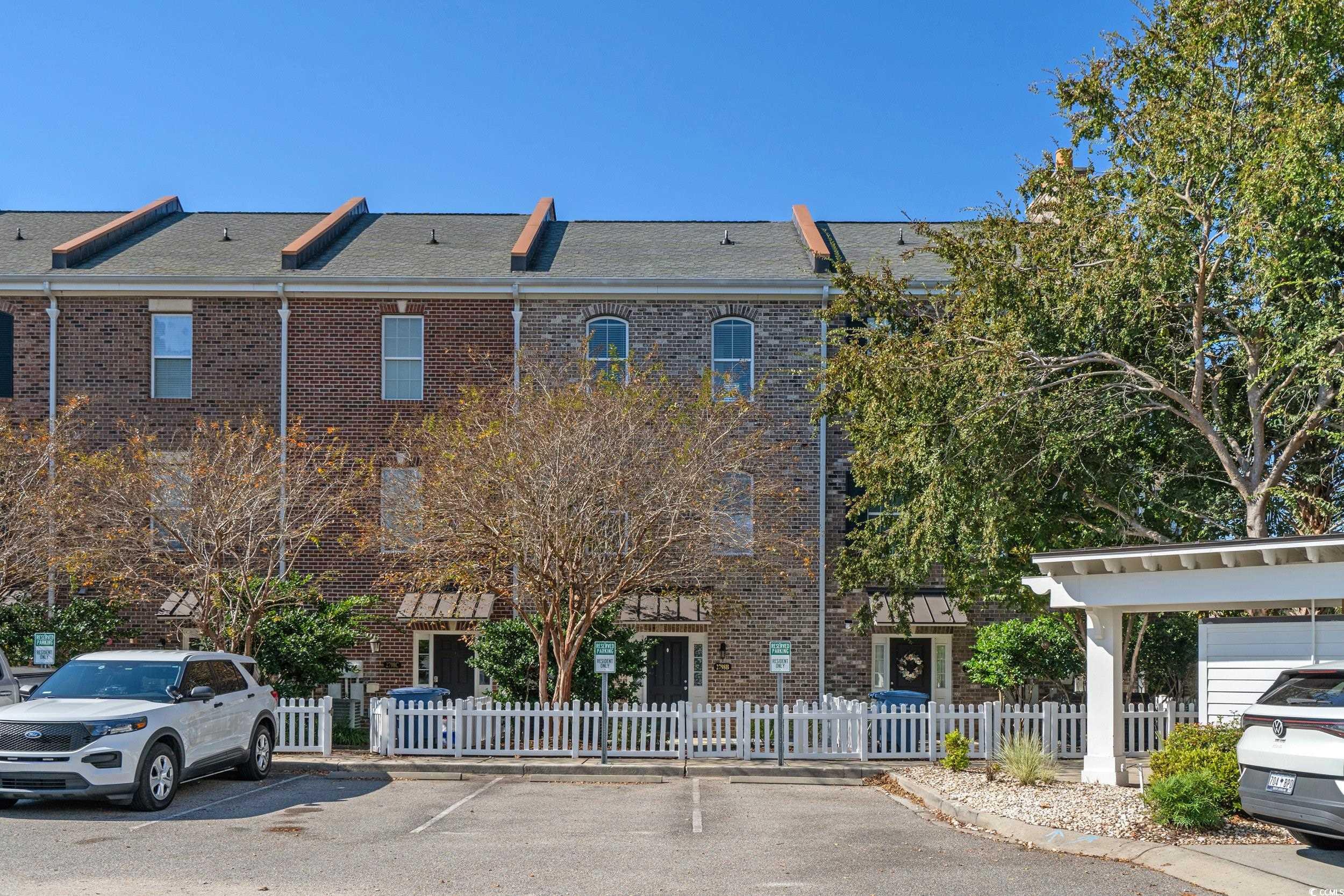 2798 Howard Avenue, Unit B Myrtle Beach, SC 29577 - Photo 3 of 40 View of building exterior featuring a fenced back yard and uncovered parking