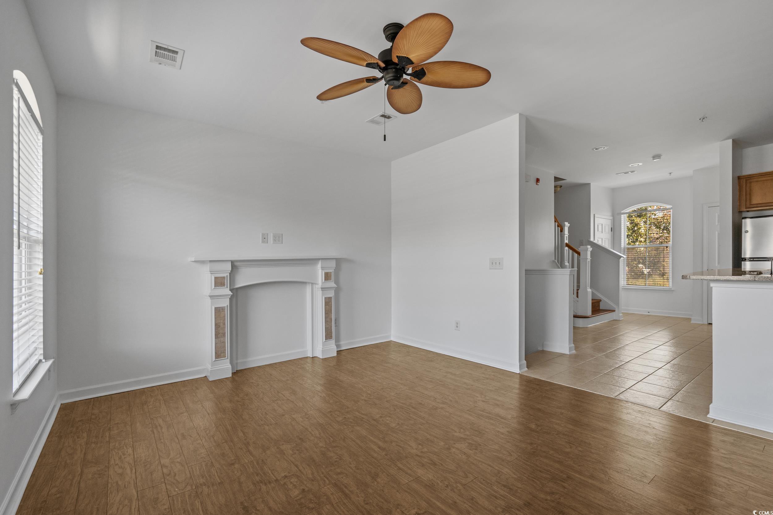 2798 Howard Avenue, Unit B Myrtle Beach, SC 29577 - Photo 7 of 40 Unfurnished living room with light wood-style flooring, stairway, and ceiling fan
