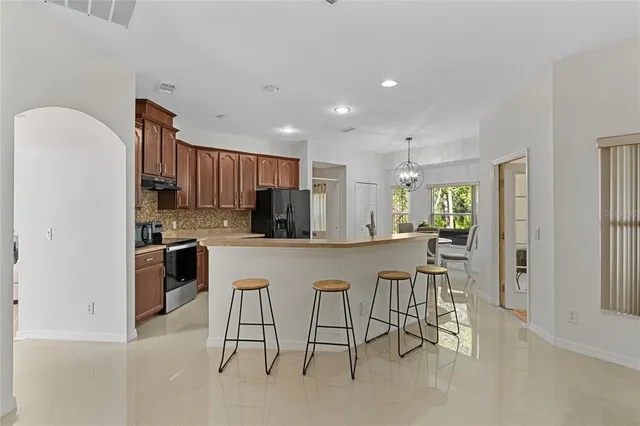 a kitchen with cabinets and chairs