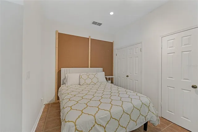 a large bed in a white room