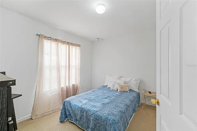 a bedroom with furniture and a window