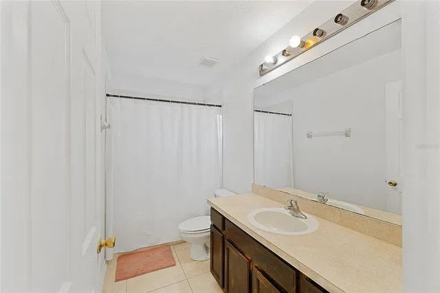 a bedroom with a bed couch and window