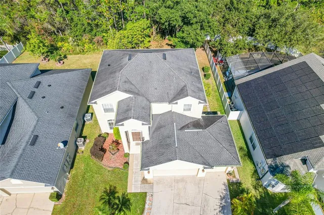 an aerial view of houses with yard
