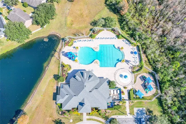 an aerial view of a residential houses with yard