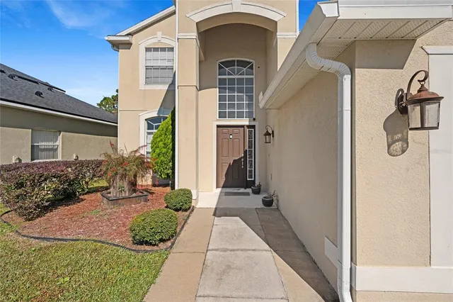 a view of a front door and small yard