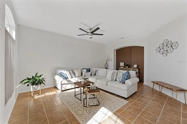 a living room with furniture and a potted plant