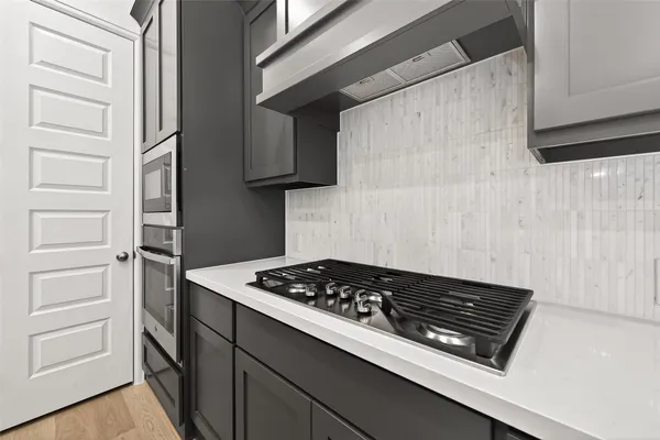 a kitchen with a stove and a refrigerator