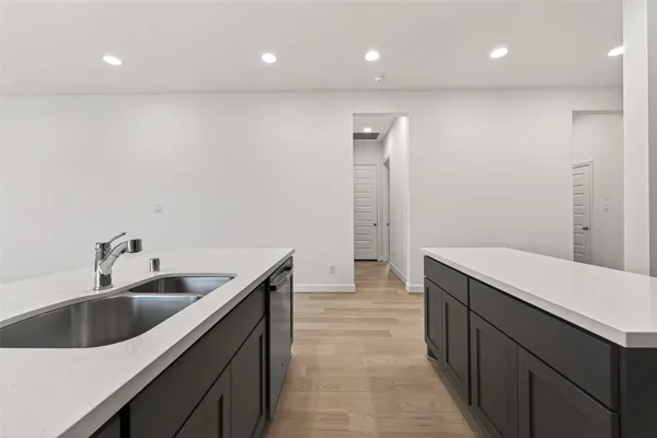 a kitchen with a sink and refrigerator
