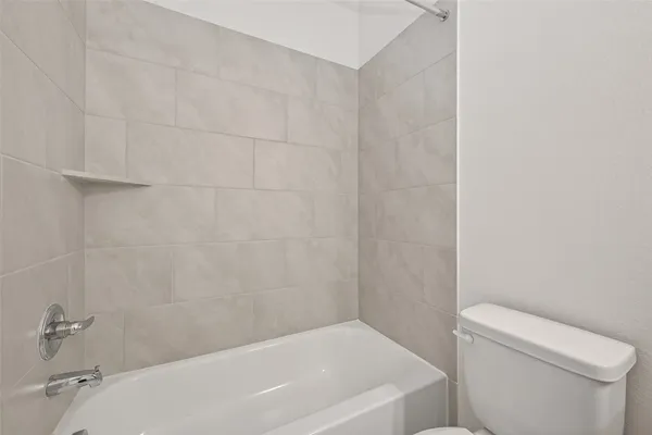 a bathroom with a bathtub and toilet