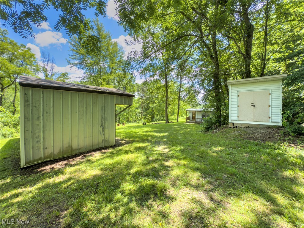 36475 Kinney Ridge Road Woodsfield, OH 43793 - Photo 8 of 50 View of green lawn with a storage unit