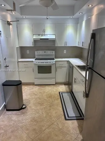 a kitchen with a stove and a refrigerator