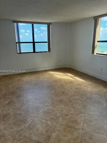 an empty room with a empty space and windows