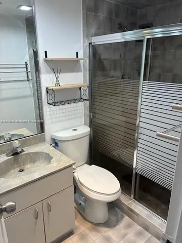 a white toilet sitting next to a bathroom sink