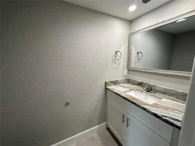 a view of a kitchen with a sink and cabinets
